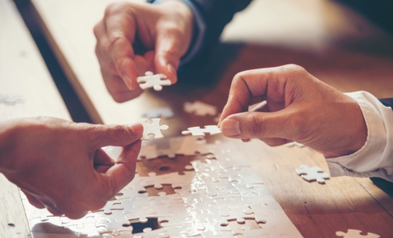 Three people putting together a puzzle